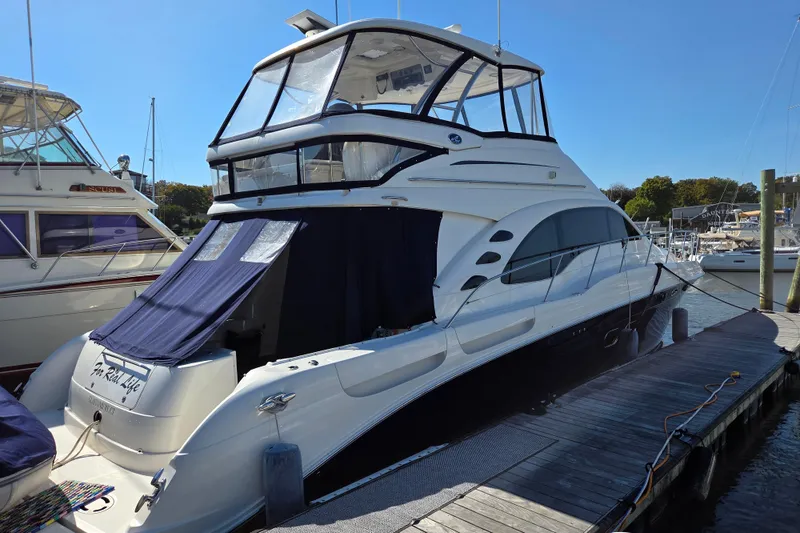 The Image of 2007 Sea Ray 580 Sedan Bridge yacht docked at marina under clear blue sky. - 0