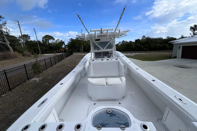 Slide: The Image of 2004 Yellowfin 36 Offshore boat with spacious deck and seating, under a clear blue sky. - 10