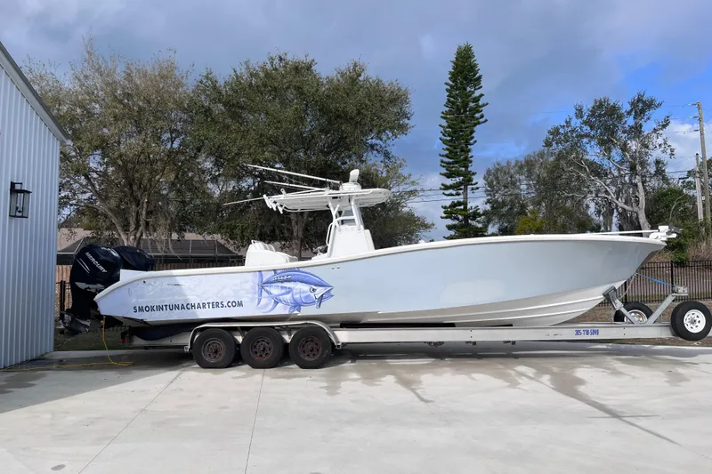 The Image of 2004 Yellowfin 36 Offshore boat on trailer, featuring fishing charter branding. - 2