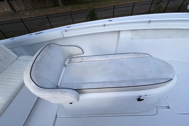 Slide: The Image of 2004 Yellowfin 36 Offshore boat seat with white upholstery and black trim. - 31