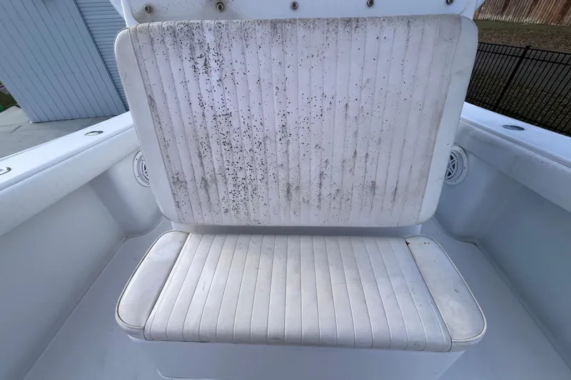 Slide: The Image of 2004 Yellowfin 36 Offshore boat seat with visible wear and mildew stains. - 32