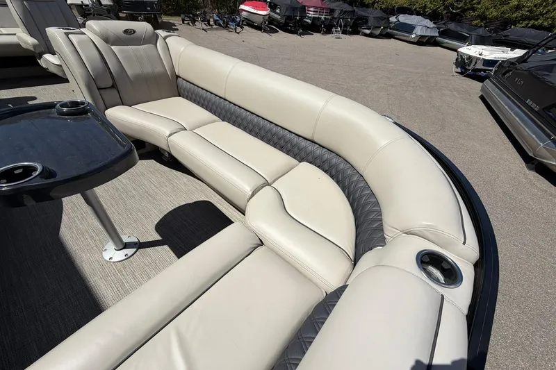 Slide: The Image of Luxurious seating on a 2020 Barletta L25U pontoon boat with cup holders and table. - 10