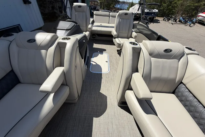 Slide: The Image of Luxurious interior of 2020 Barletta L25U pontoon boat with plush seating and cup holders. - 11
