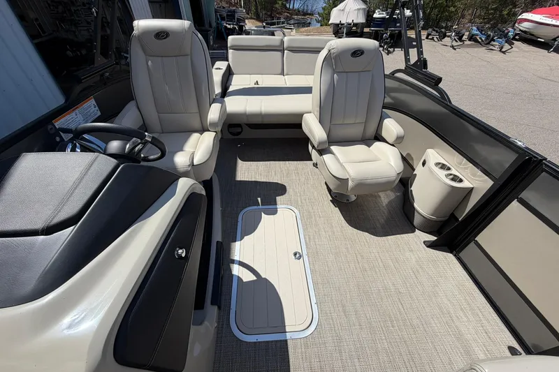 Slide: The Image of 2020 Barletta L25U pontoon boat interior with plush seating and modern helm. - 13