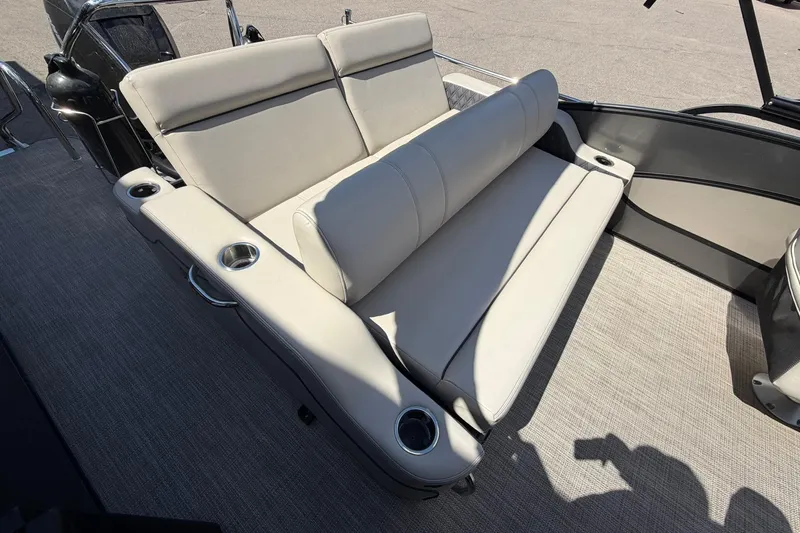 Slide: The Image of 2020 Barletta L25U boat interior with beige seating and cup holders. - 16