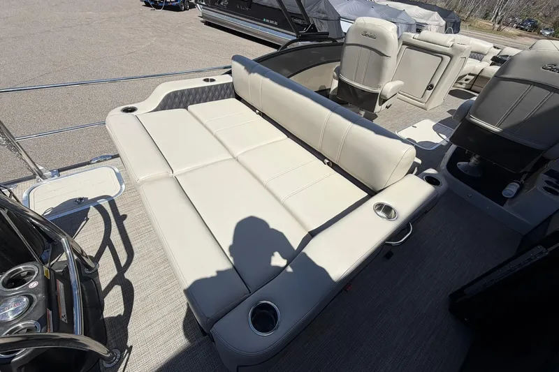 Slide: The Image of 2020 Barletta L25U pontoon boat interior with beige seating and cup holders. - 17