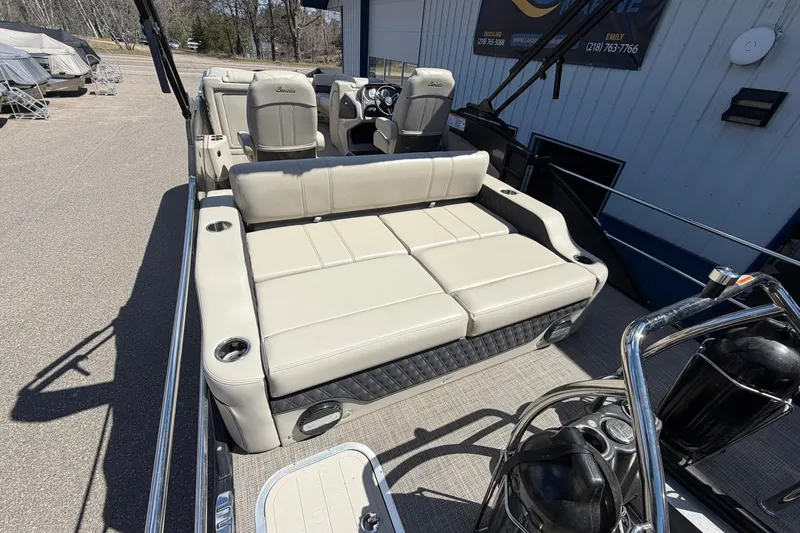 Slide: The Image of 2020 Barletta L25U pontoon boat interior with beige seating and cup holders. - 19