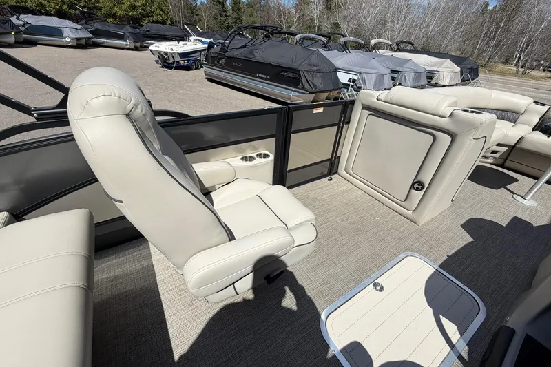 Slide: The Image of 2020 Barletta L25U pontoon boat interior with beige seating and storage compartments. - 23