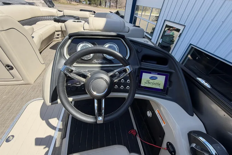 Slide: The Image of 2020 Barletta L25U boat dashboard with steering wheel and digital display. - 26