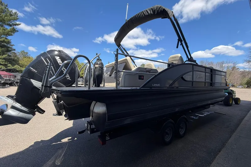 Slide: The Image of 2020 Barletta L25U pontoon boat with Mercury engine on a trailer. - 4
