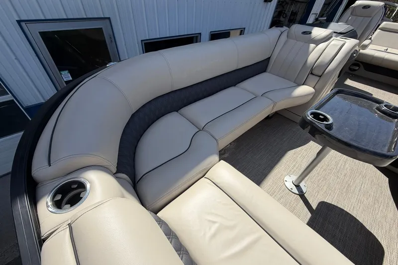 Slide: The Image of Luxurious seating on a 2020 Barletta L25U pontoon boat with cup holders and table. - 9