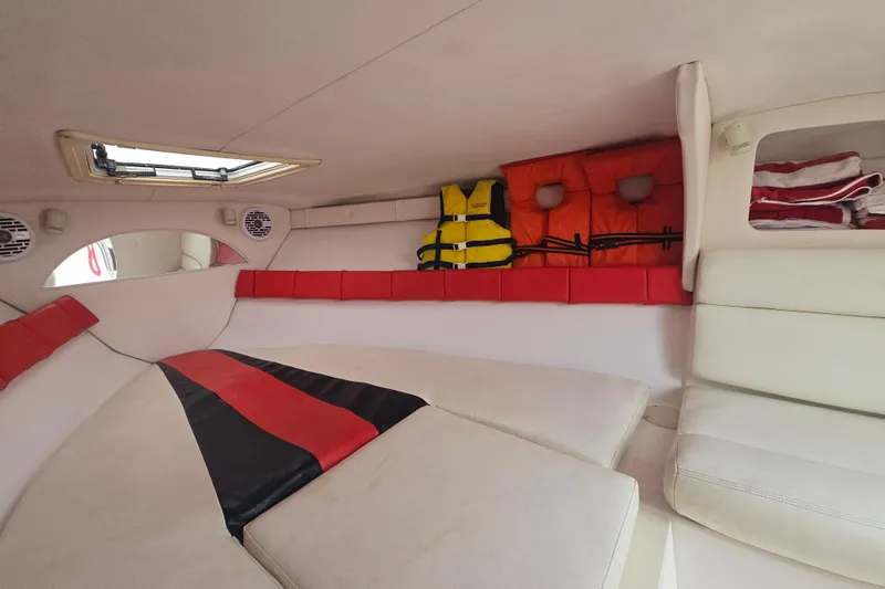 Slide: The Image of Interior of a 1999 Donzi 28 ZX boat with life jackets and cushions. - 12