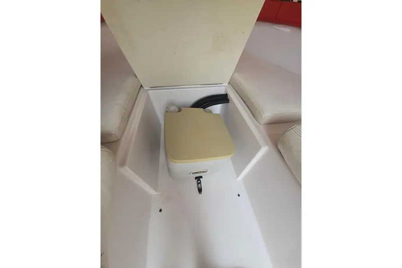 Slide: The Image of Interior of a 1999 Donzi 28 ZX boat featuring a portable toilet. - 13