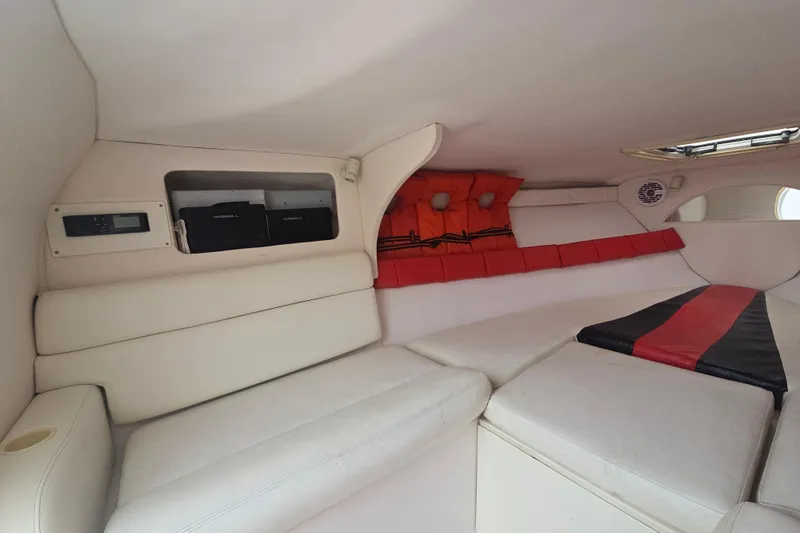 Slide: The Image of Interior of a 1999 Donzi 28 ZX boat, featuring white seating and red accents. - 14