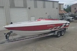 Slide: The Image of 1999 Donzi 28 ZX speedboat with red and white design on a trailer. - 5