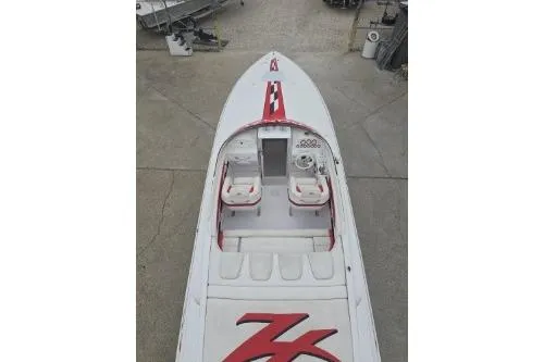 Slide: The Image of 1999 Donzi 28 ZX speedboat with red accents, viewed from above, showcasing cockpit and seating. - 7
