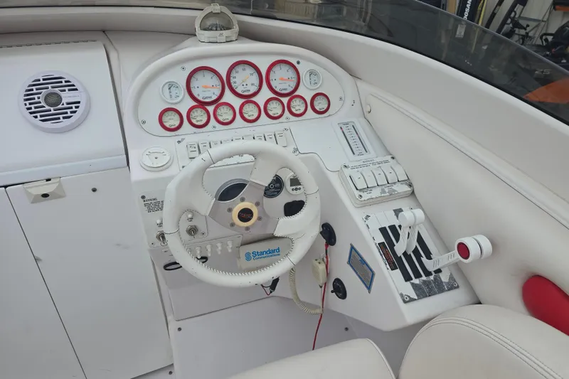 Slide: The Image of 1999 Donzi 28 ZX boat cockpit with steering wheel, gauges, and control panel. - 8