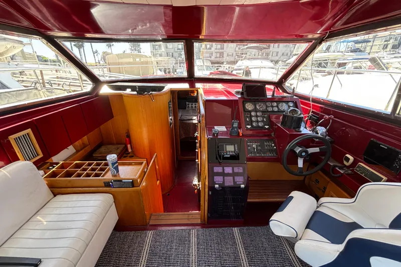 Slide: The Image of Interior of a 1984 Posillipo Technema yacht with steering controls and seating. - 10
