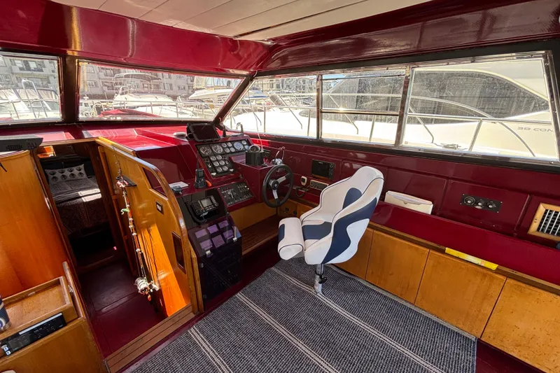 Slide: The Image of Interior of a 1984 Posillipo Technema yacht with red and wood accents. - 11