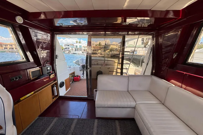 Slide: The Image of Interior of 1984 Posillipo Technema yacht with white seating and waterfront view. - 12