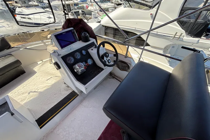 Slide: The Image of Cockpit of a 1984 Posillipo Technema yacht with steering wheel and navigation equipment. - 15