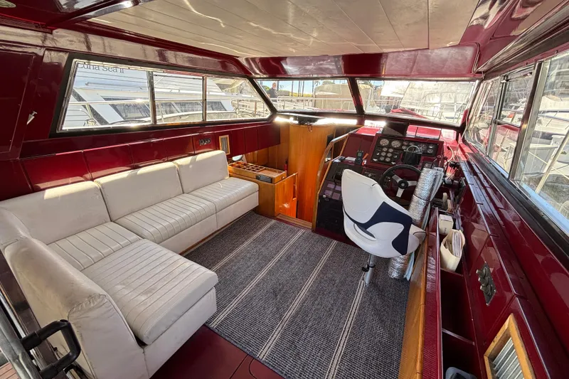Slide: The Image of Interior of a 1984 Posillipo Technema yacht with white seating and a modern helm. - 16