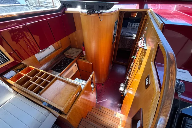 Slide: The Image of Interior of 1984 Posillipo Technema yacht with wooden cabinetry and compact kitchen area. - 6