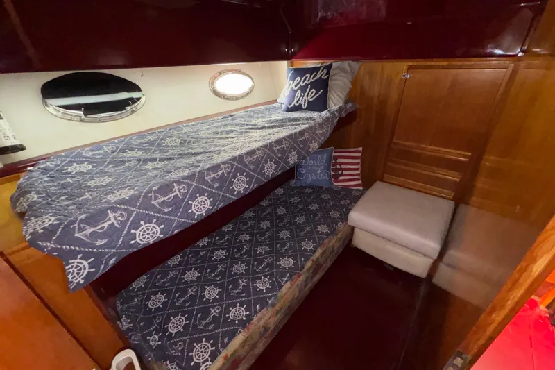 Slide: The Image of Cozy cabin interior of 1984 Posillipo Technema yacht with nautical-themed bedding. - 8