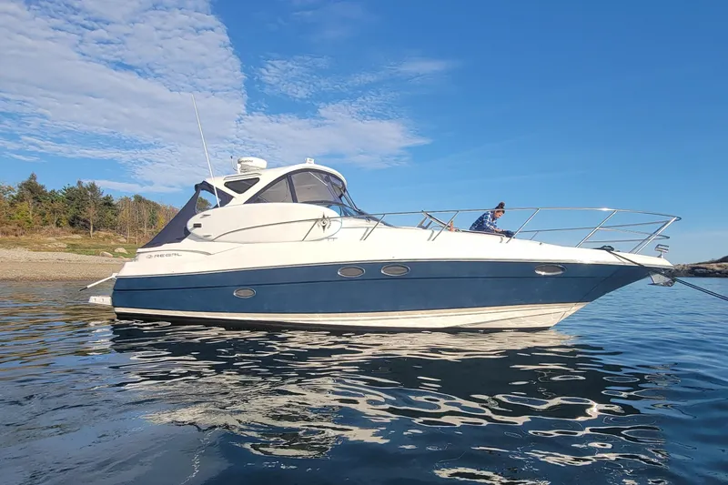 The Image of 2007 Regal Commodore 3760 IB yacht on calm water under clear blue sky. - 0