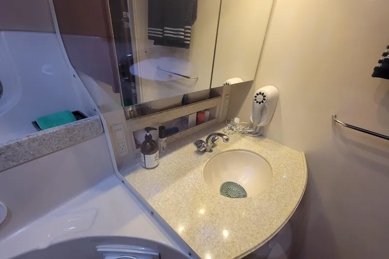 Slide: The Image of 2007 Regal Commodore 3760 IB bathroom with sink, mirror, and hairdryer. - 10