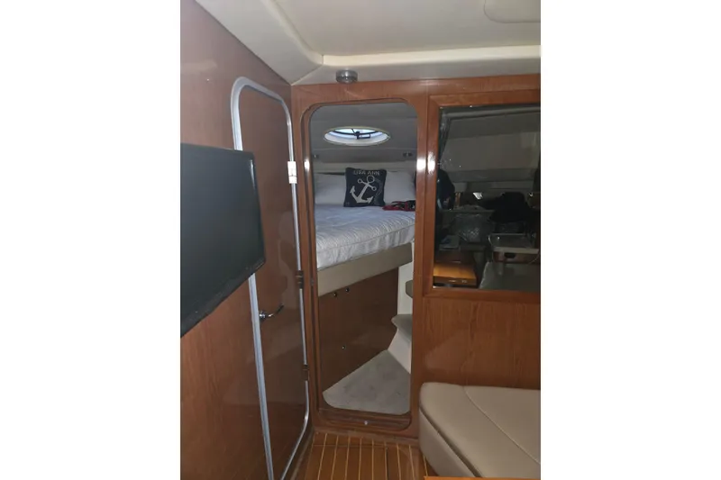 Slide: The Image of Interior cabin of 2007 Regal Commodore 3760 IB yacht with wood paneling and bed. - 14