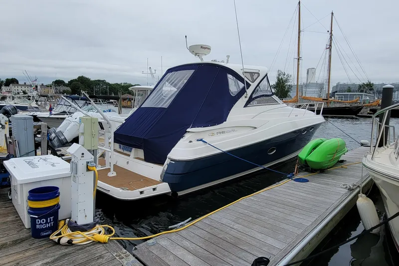 Slide: The Image of 2007 Regal Commodore 3760 IB yacht docked at marina with kayaks and equipment. - 16