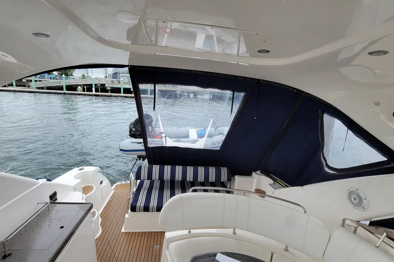Slide: The Image of 2007 Regal Commodore 3760 IB yacht interior with striped seating and water view. - 17