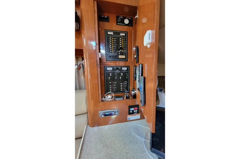 Slide: The Image of Electrical panel inside 2007 Regal Commodore 3760 IB yacht, featuring control switches and meters. - 19