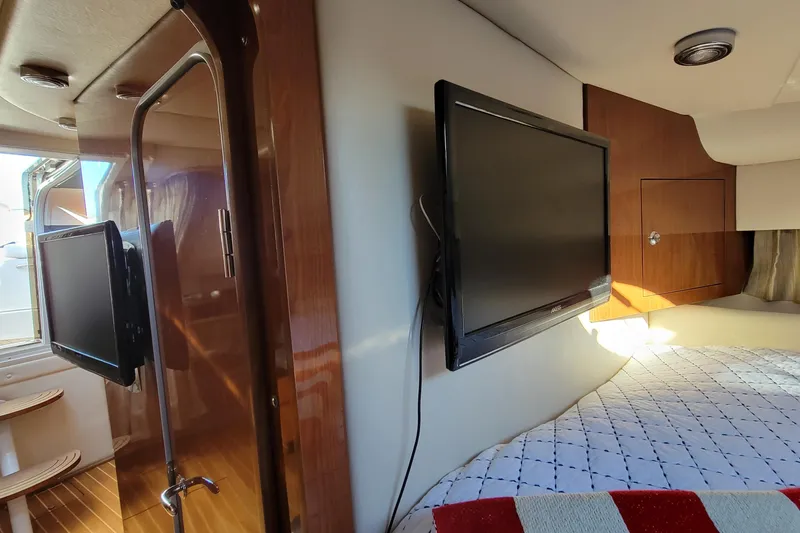 Slide: The Image of Interior of 2007 Regal Commodore 3760 IB with mounted TV and cozy cabin space. - 20