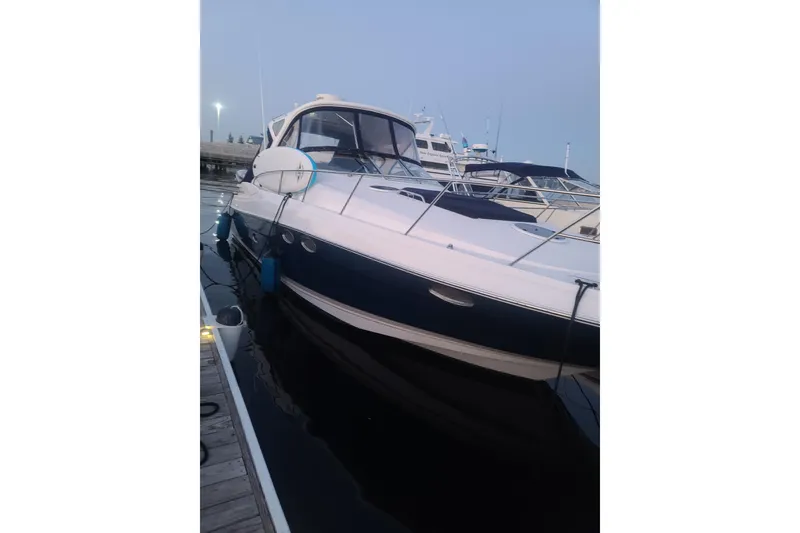 Slide: The Image of 2007 Regal Commodore 3760 IB yacht docked at marina during twilight. - 22