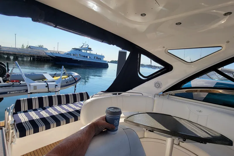 Slide: The Image of 2007 Regal Commodore 3760 IB interior with marina view, featuring a cozy seating area. - 24