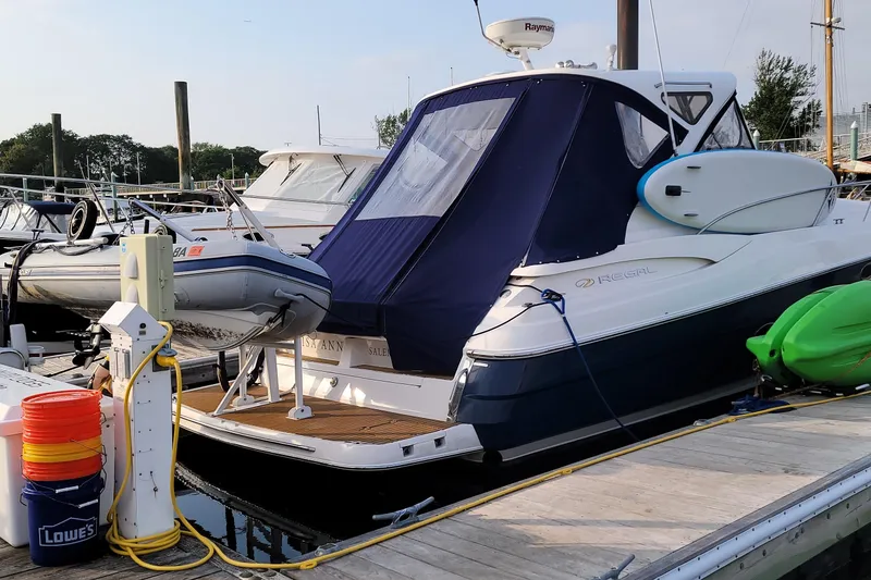 Slide: The Image of 2007 Regal Commodore 3760 IB yacht docked with inflatable boat and kayak nearby. - 26