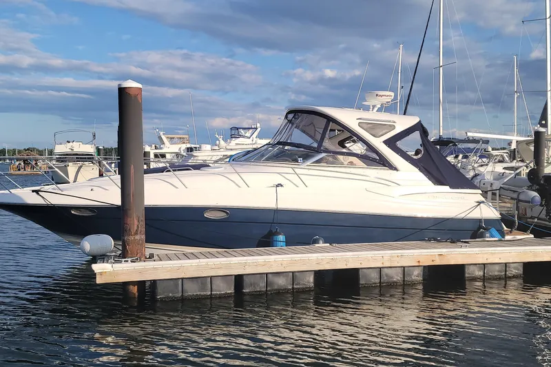 Slide: The Image of 2007 Regal Commodore 3760 IB yacht docked at marina under blue sky. - 27