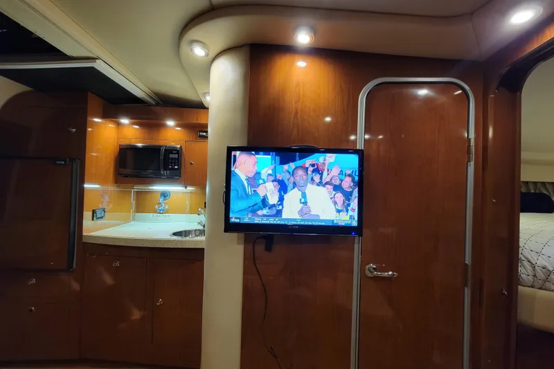 Slide: The Image of Interior of 2007 Regal Commodore 3760 IB yacht with TV and kitchenette. - 3