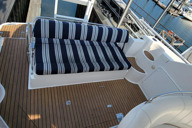 Slide: The Image of 2007 Regal Commodore 3760 IB boat deck with striped seating and wooden flooring. - 32