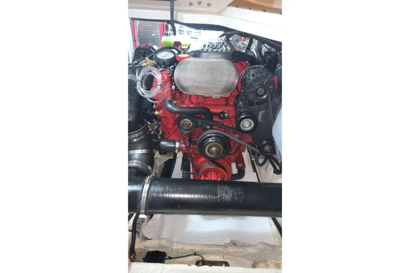 Slide: The Image of Engine compartment of a 2007 Regal Commodore 3760 IB boat, showcasing red engine components. - 34