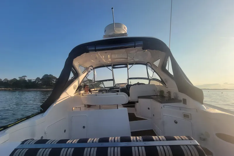 Slide: The Image of 2007 Regal Commodore 3760 IB yacht interior with seating, cruising on calm waters at sunset. - 40