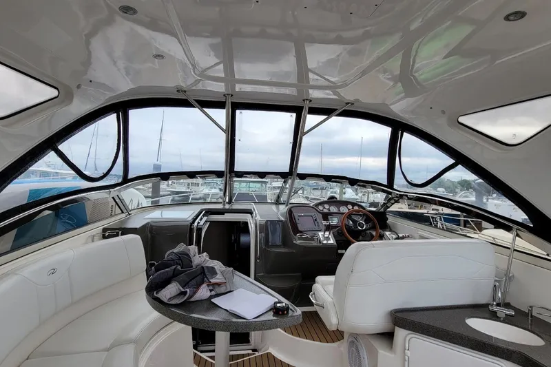 Slide: The Image of Interior view of a 2007 Regal Commodore 3760 IB yacht, featuring a sleek helm and seating area. - 44
