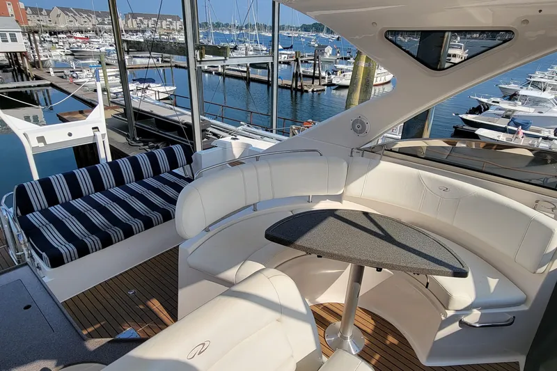 Slide: The Image of Luxurious 2007 Regal Commodore 3760 IB yacht interior with elegant seating and marina view. - 5