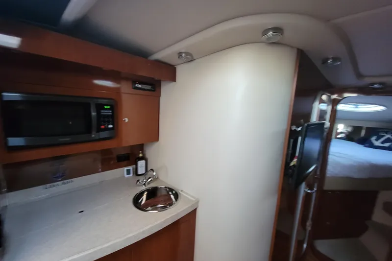 Slide: The Image of 2007 Regal Commodore 3760 IB yacht interior with kitchenette and cozy sleeping area. - 6
