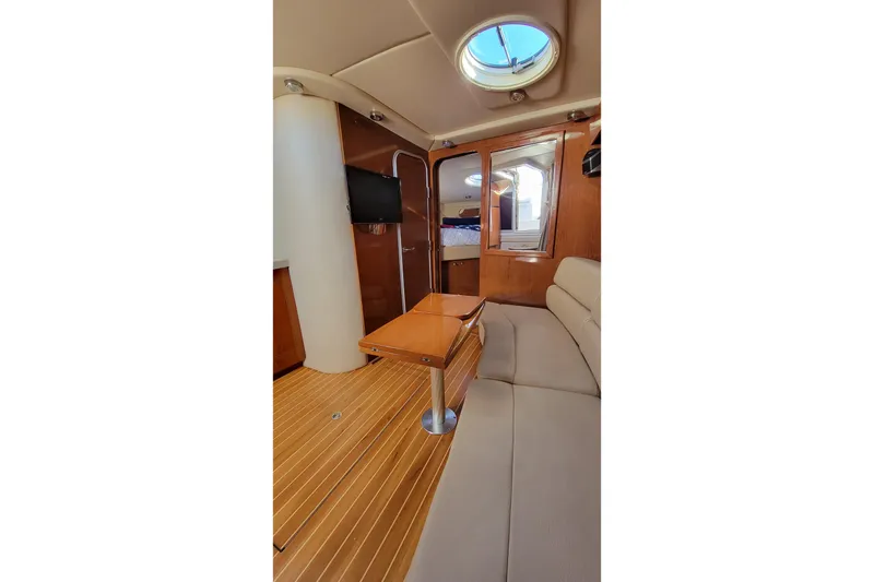 Slide: The Image of Interior of 2007 Regal Commodore 3760 IB yacht with wood accents and seating area. - 8