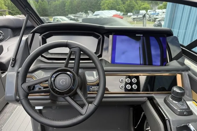 Slide: The Image of 2026 Godfrey Sanpan 2700 ULW Twin dashboard with steering wheel and digital display. - 20