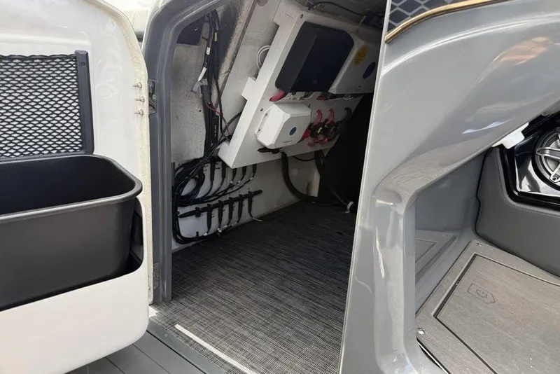 Slide: The Image of Interior view of 2026 Godfrey Sanpan 2700 ULW Twin, showcasing wiring and storage compartments. - 24