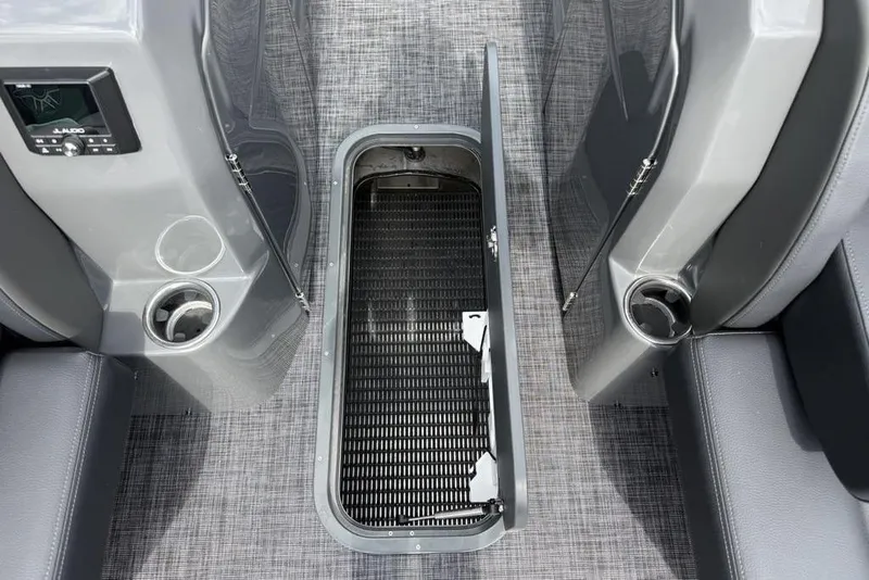 Slide: The Image of Interior of 2026 Godfrey Sanpan 2700 ULW Twin with open storage compartment and cup holders. - 25